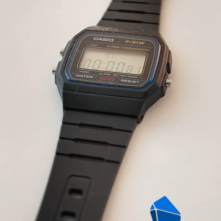 The watch closed again, with the time on its display.